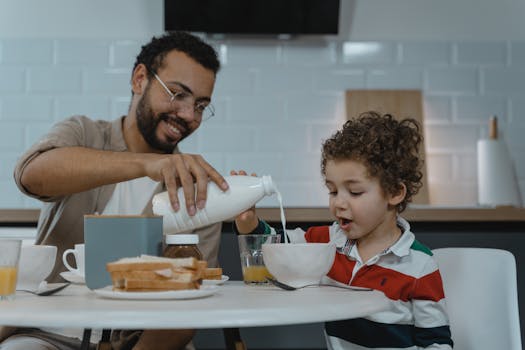 A joyful father and son having breakfast together at home. Calm and loving atmosphere.