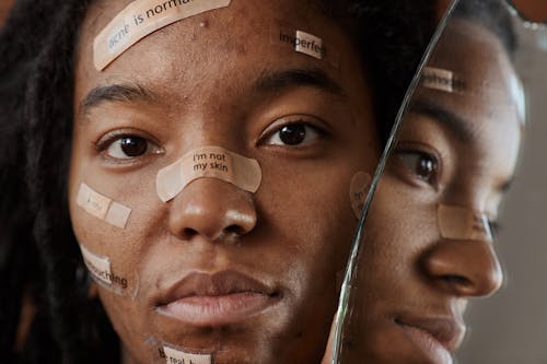 A Woman Protesting with Messages on Band Aids 