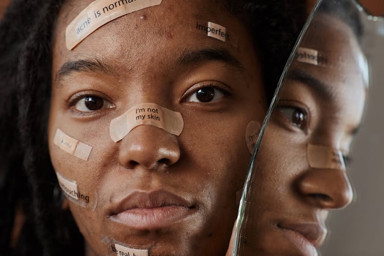 A Woman Protesting With Messages On Band Aids 