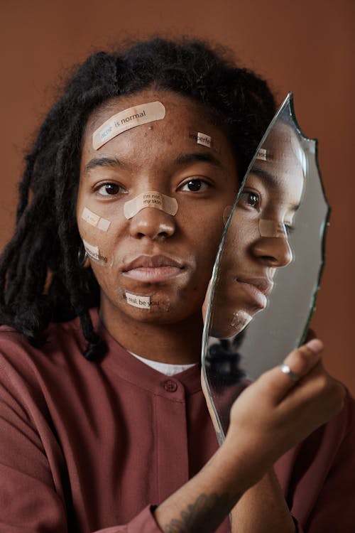 Close-Up Photo of Woman's Face near a Broken Mirror
