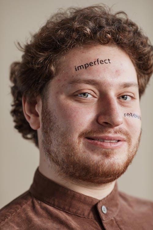 A Bearded Man with Printed Message on His Smiling at the Camera