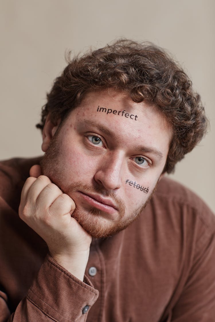 A Man With Words Written On Face