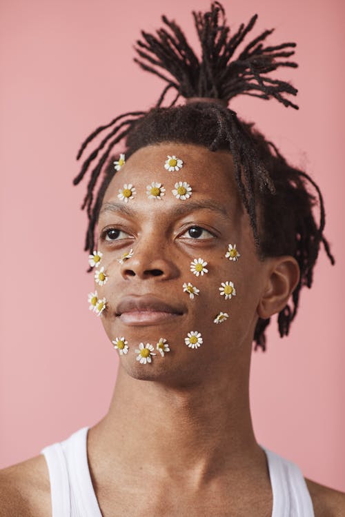 A Man with Tied Hair and Flowers on His Face