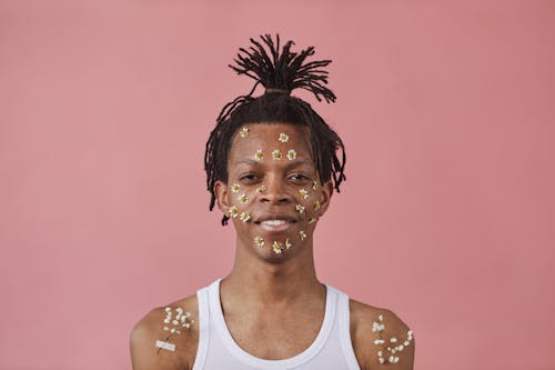 Man in White Tank Top With Flowers on Face