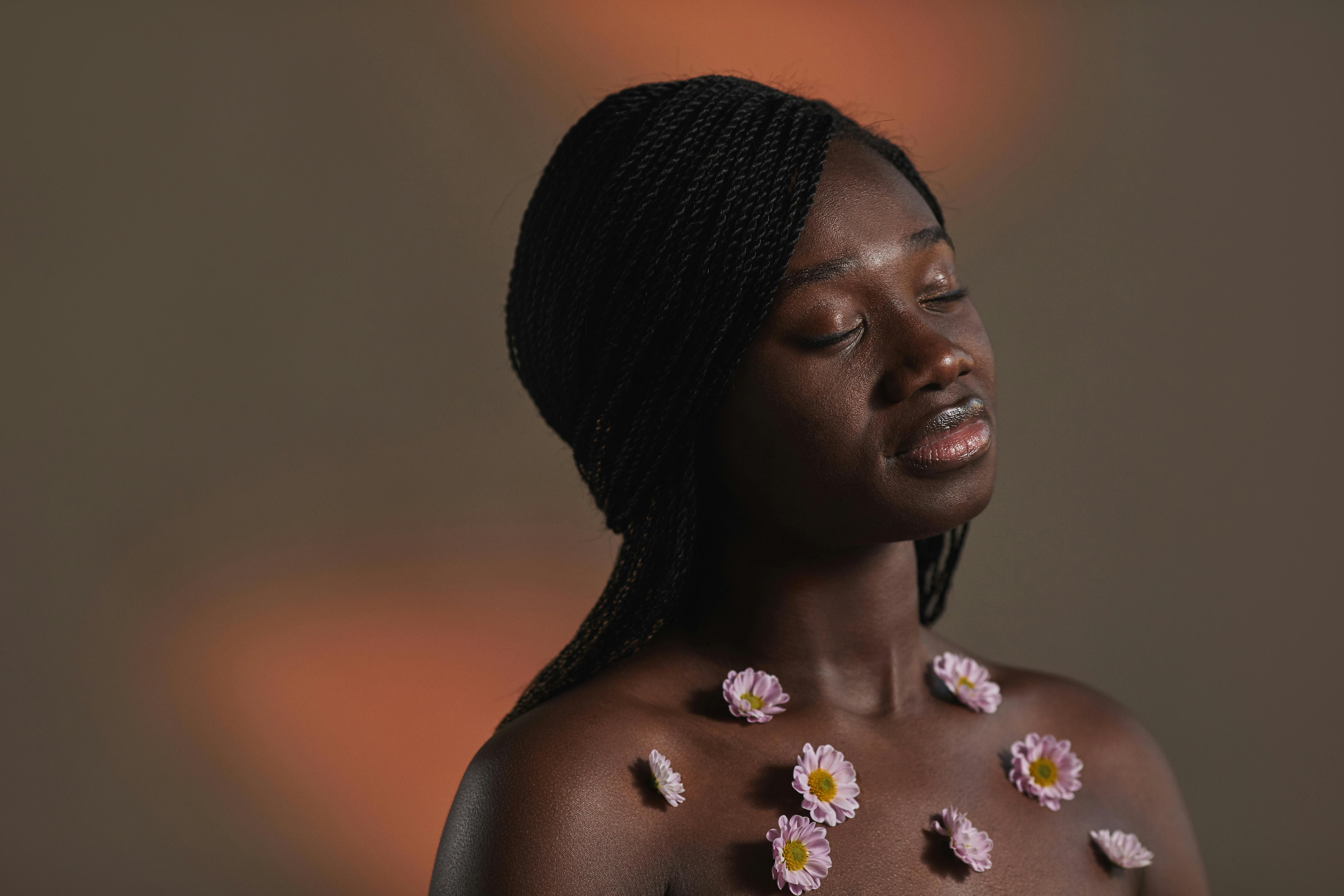 a woman with flowers glued on bare chest