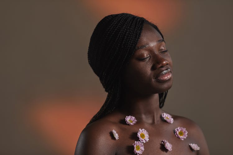 A Woman With Flowers Glued On Bare Chest