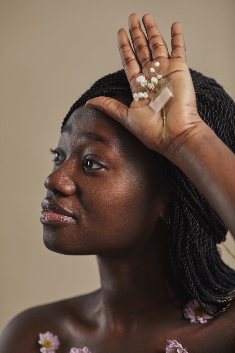 A Woman With Flower And Band Aid On Her Palm