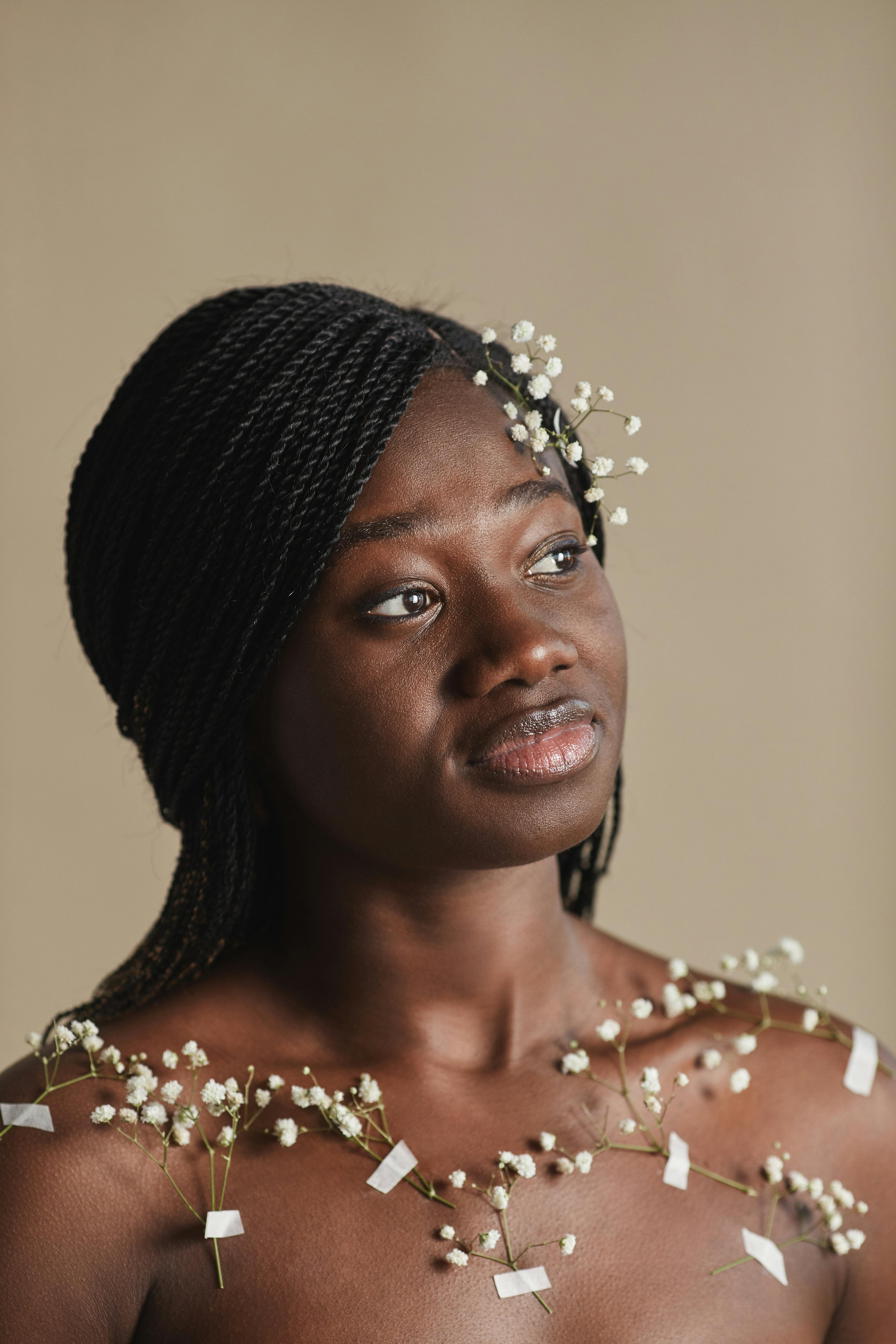 a woman with baby s breath flowers taped on bare chest