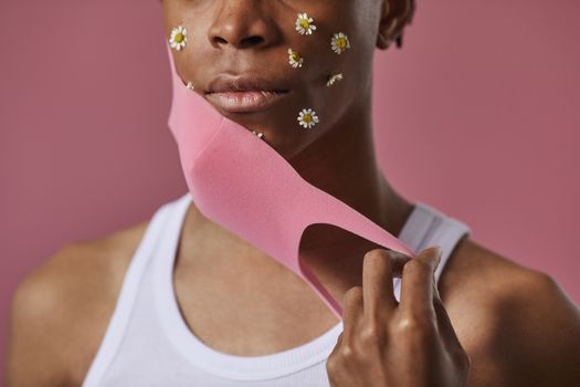 Man Taking off Protective Mask and Have Flowers Underneath 