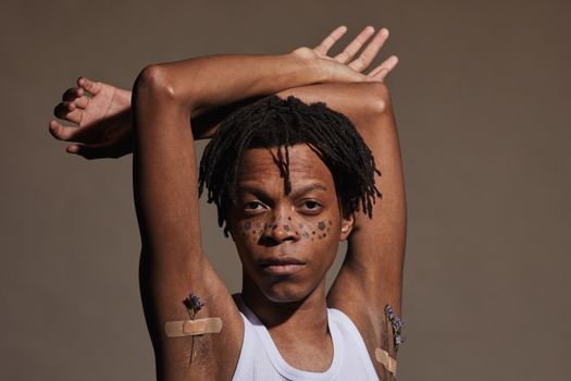 Man in White Tank Top With White Band Aid on His Face