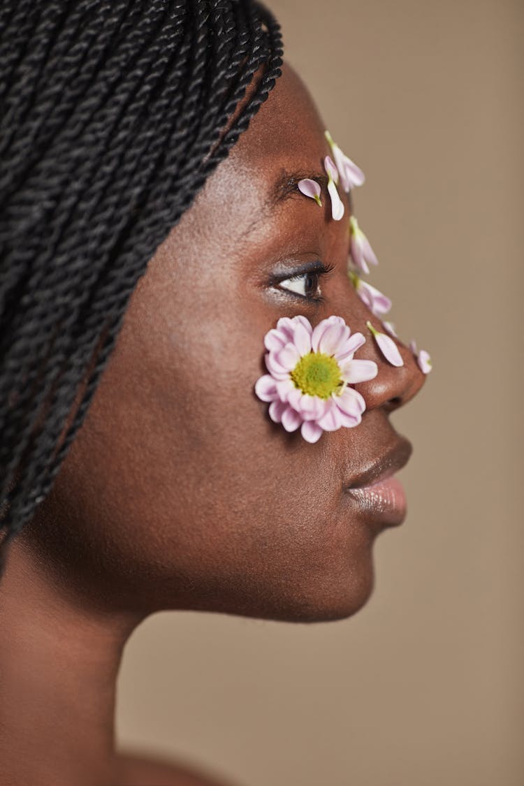 A Profile Of A Woman With Flowers On Face