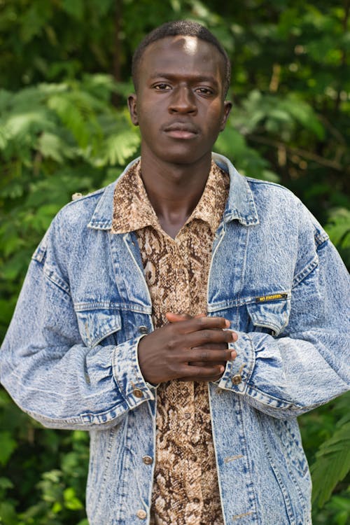 Free Man Wearing a Denim Jacket Over a Printed Polo Stock Photo