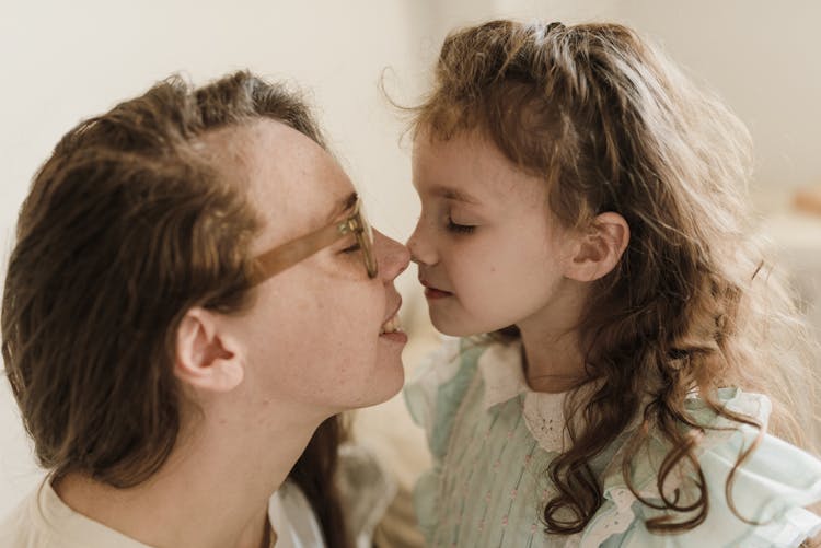 Mother And Daughter Doing Nose To Nose