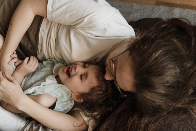 A Mother And Daughter Laughing