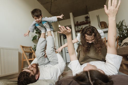 Free A Couple Playing Airplanes with their Children Stock Photo