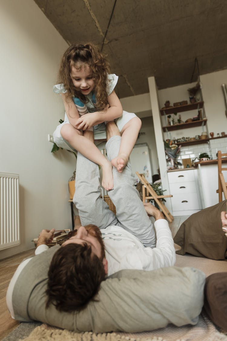 A Father Lifting Daughter With His Feet