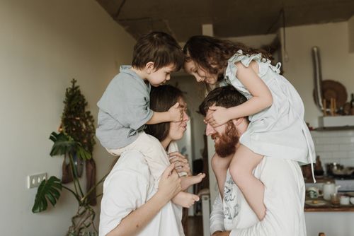 Free A cheerful family enjoying playful bonding time together in a cozy home setting. Stock Photo