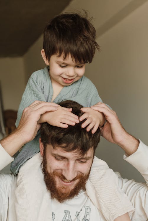 Free A Father Carrying Son on his Shoulders Stock Photo