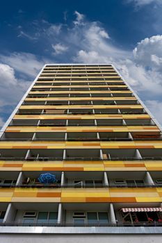 View of a tall, vibrant residential building under a clear sky in Berlin.