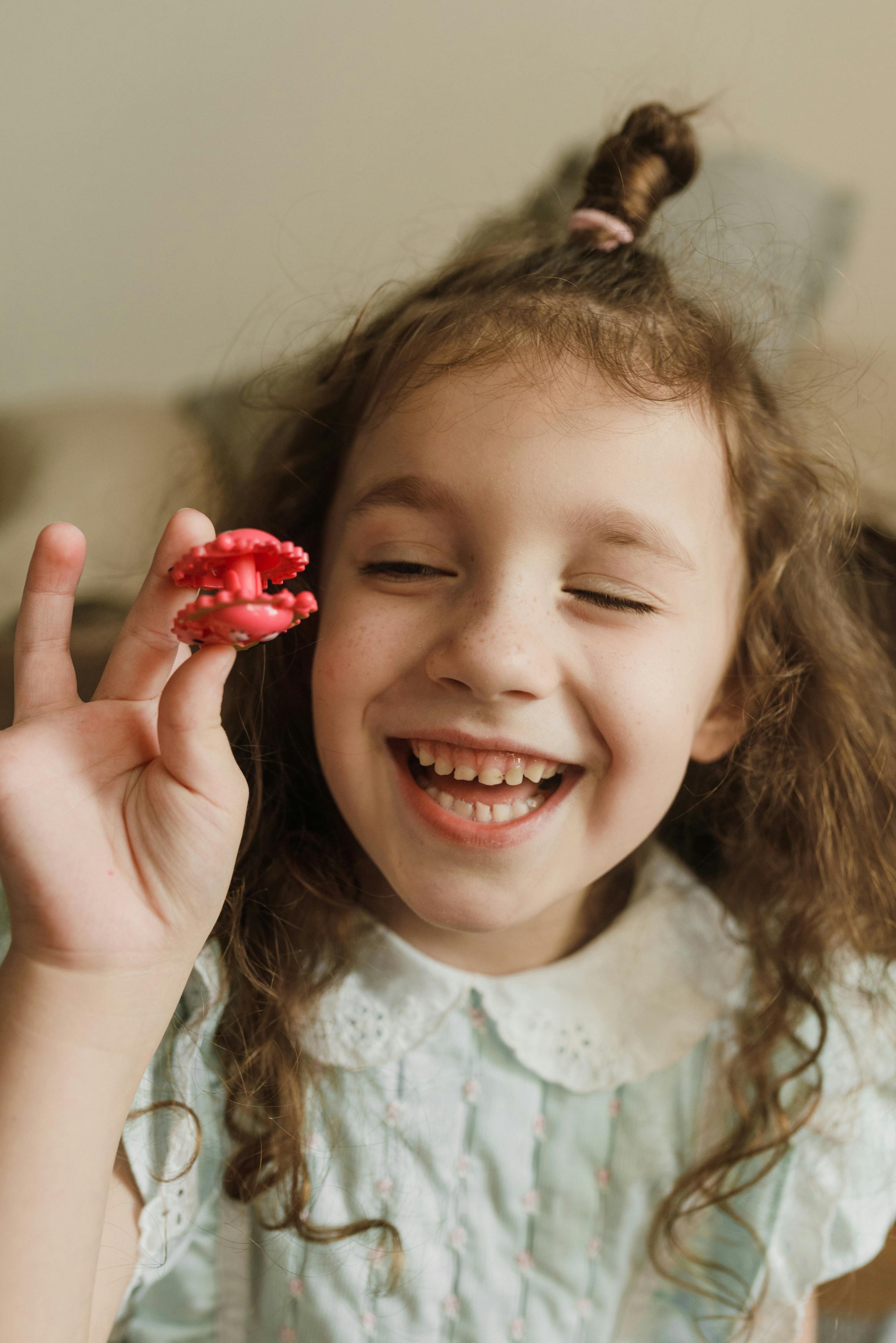 a portrait of a girl holding a toy