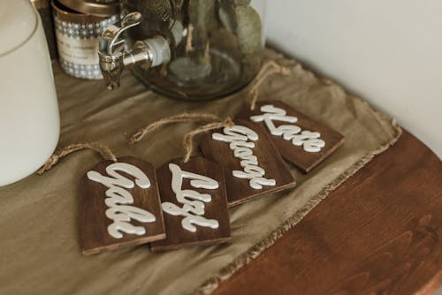 Free Wooden Name Tags on the Brown Fabric Stock Photo