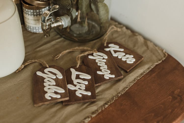 Wooden Name Tags On The Brown Fabric