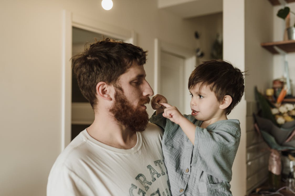 Free Bearded Man Carrying a Boy Stock Photo