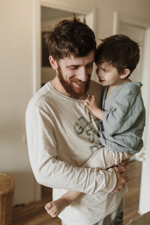 Free Man Carrying His Son Stock Photo