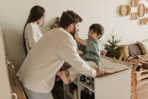 Free A father and son share a loving moment indoors, capturing family warmth. Stock Photo
