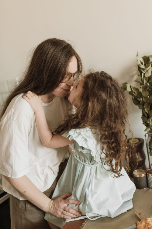 Free A mother and daughter share a joyful and loving embrace in a cozy indoor setting. Stock Photo
