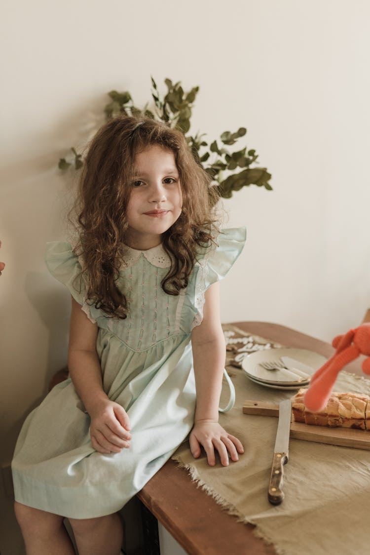 Pretty Girl In Sitting On A Wooden Counter