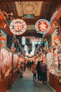 People in Illuminated Alley at Night