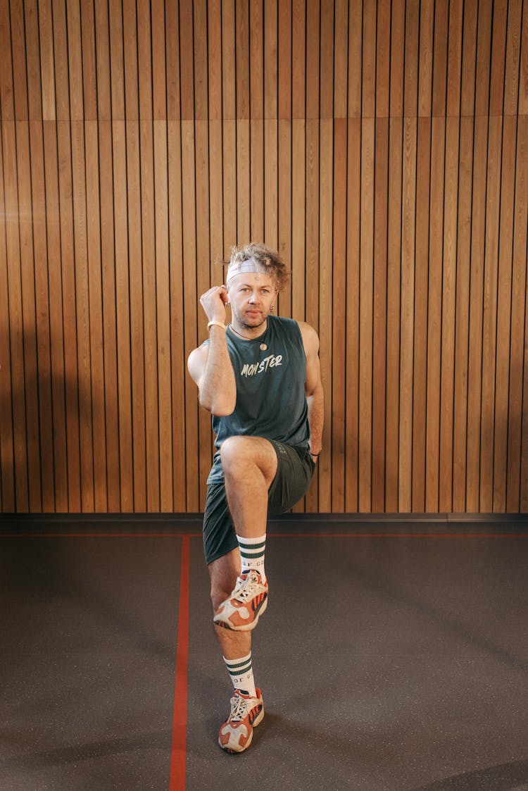 A MAn In Gray Tank Top Doing An Exercise Routine