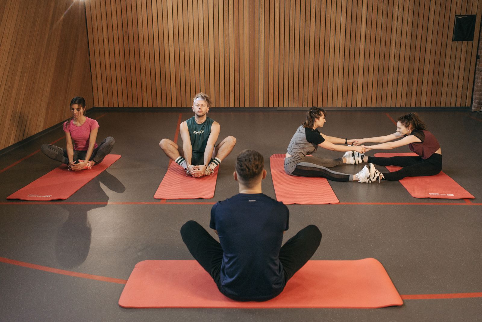 Group fitness class participants smiling with raised arms, showing improved mood during exercise