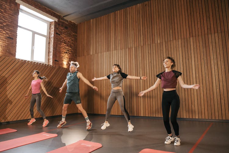 People In The Fitness Center Doing Jumping Jacks