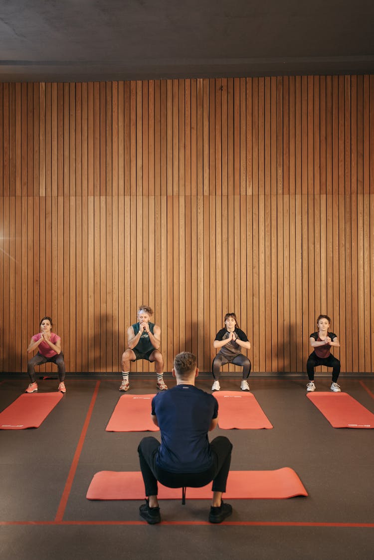 Group Of People Stretching In Yoga Studio