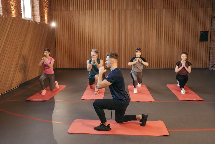 Group Of People Stretching In Yoga Studio