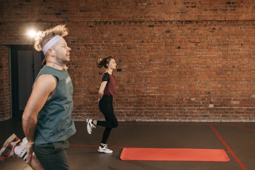 Two young adults exercising in a brick-walled gym, focusing on fitness and health.