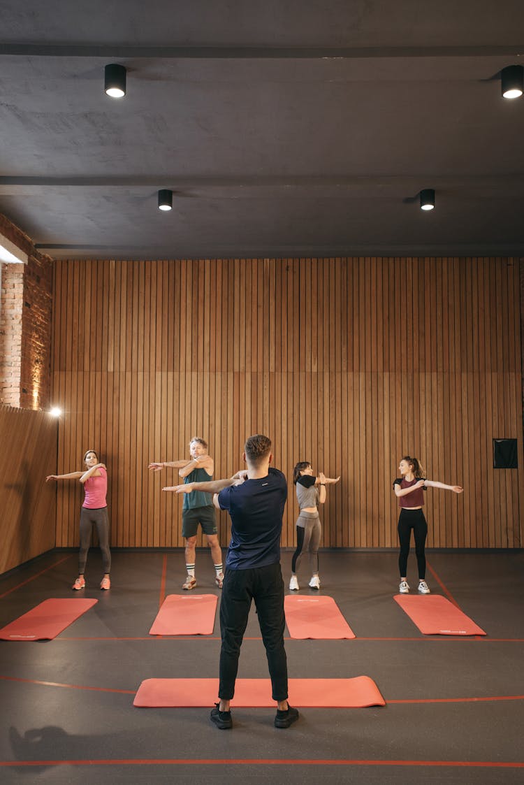 Group Of People Exercising Together 