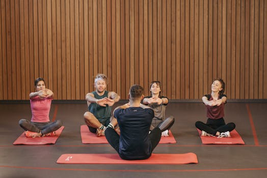 A diverse group practicing yoga in a studio with a focus on wellness and mindfulness.
