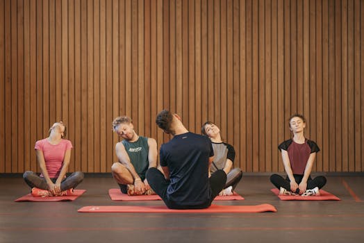 A diverse group of people practicing yoga indoors, focusing on relaxation and fitness.