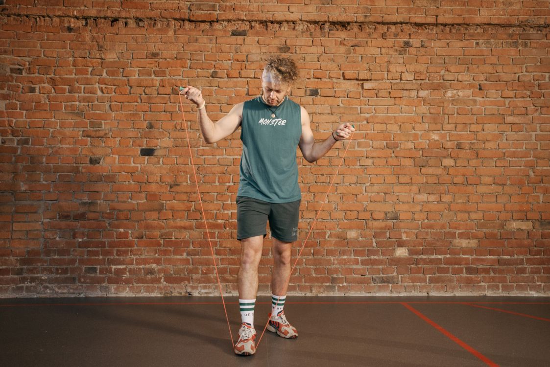 Man Using Jump Rope Model Man in Activewear Holding Jump Rope · Free Stock Photo