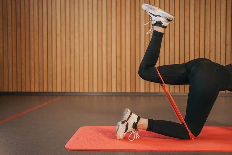 Person In Black Leggings Doing Leg Exercise With A Resistance Band