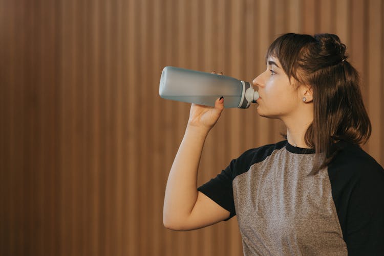 Woman Drinking Water From A Tumbler