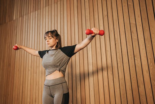 Free Woman Lifting Two Dumbbells Stock Photo