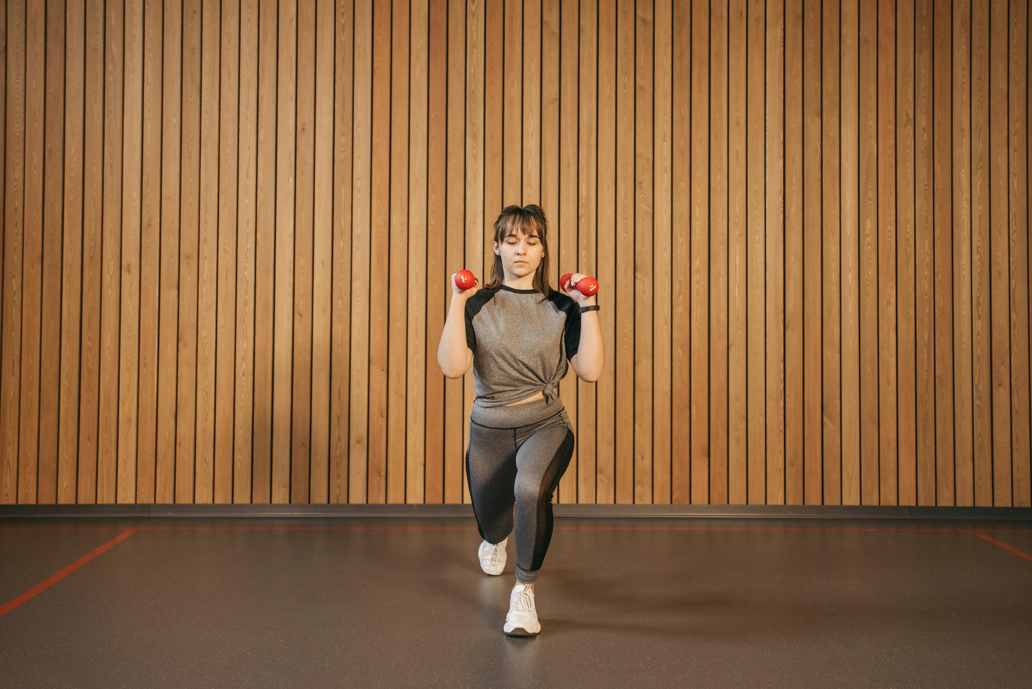 Woman in Gray Shirt Exercising