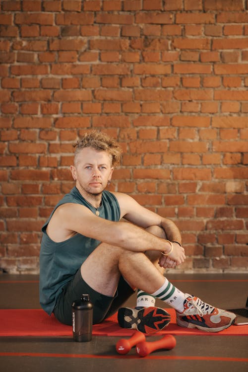 Man Sitting on Yoga Mat 