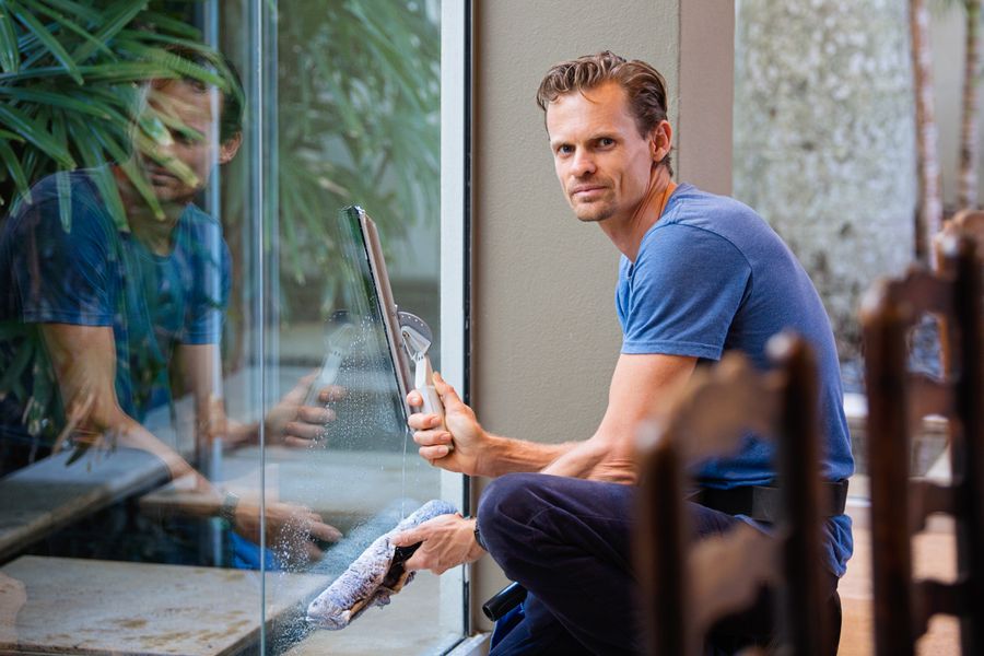 Window cleaner wiping a pane to a spotless finish