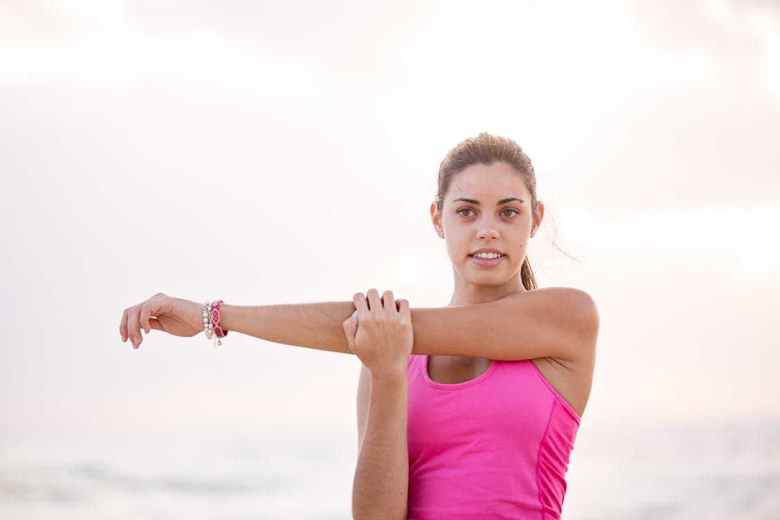 Free Photography of Woman in Pink Tank Top Stretching Arm Stock Photo
