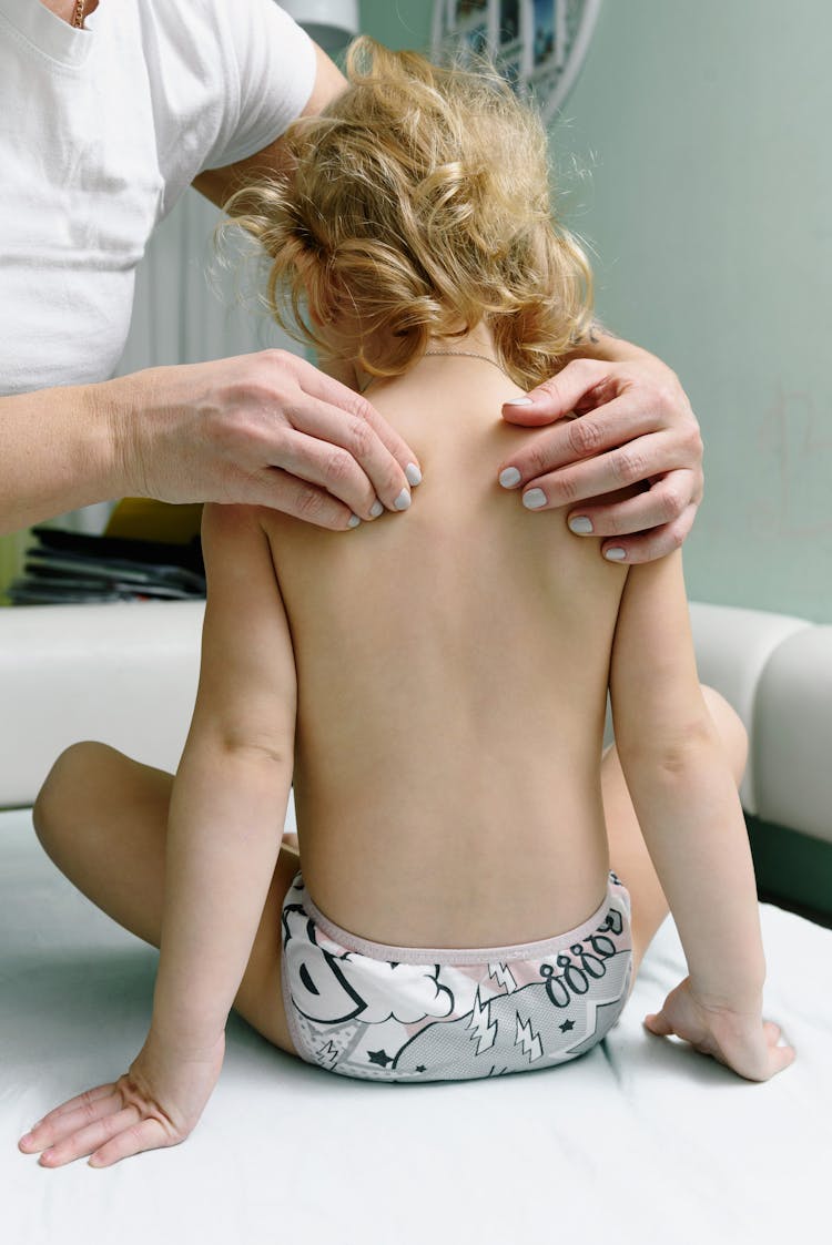 A Baby Getting A Back Massage